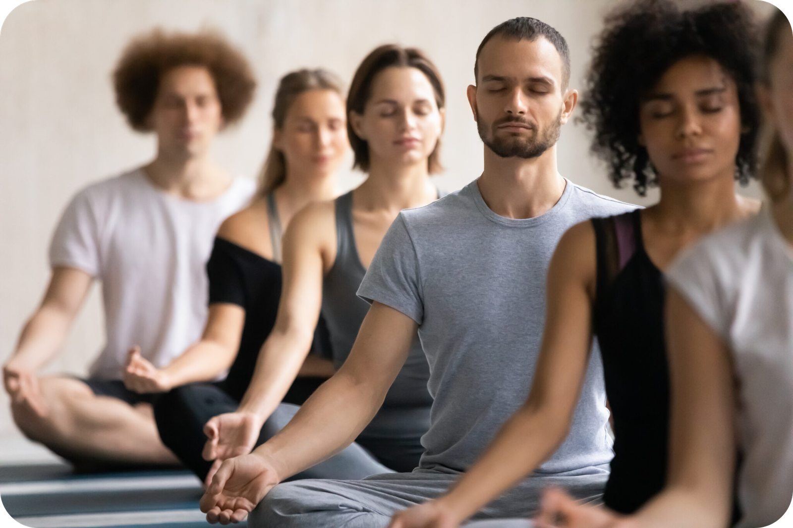 multiracial group of people practising meditation